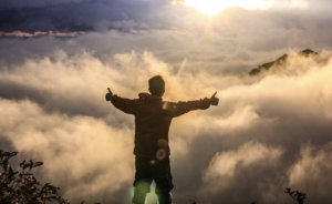 Man Thumbs Up Above Clouds